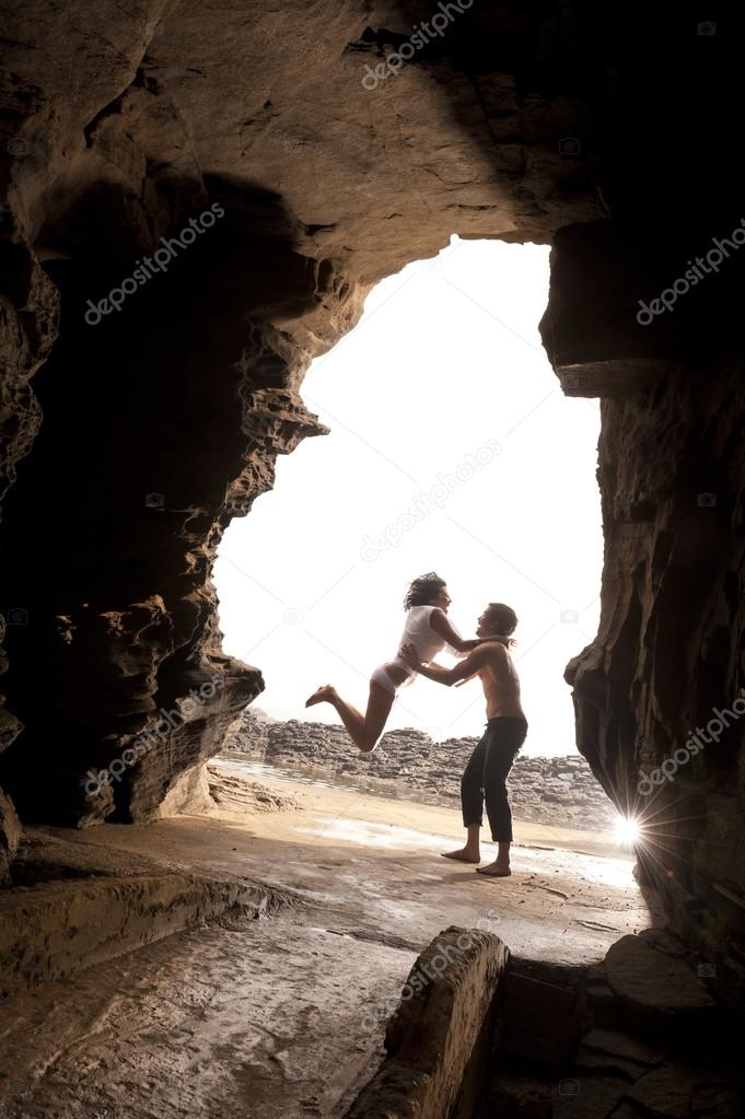 Young beautiful  in love couple having fun flirting at the beach