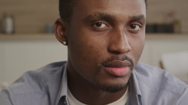 Acercamiento retrato de un hombre afroamericano adulto mirando hacia los lados y luego convertirse en cámara en mirar directamente en la lente — Vídeo de stock