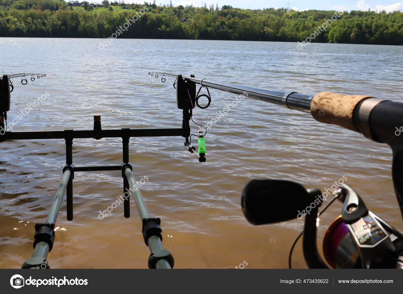 Carp fishing indicator. Warning for fishing, detailed swinger. Carp fishing  on the dam. Fishing rod on a rod pod. — Photo