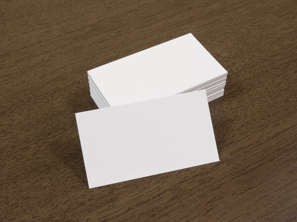  Blank business cards on a wooden background