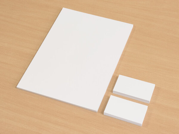 Blank business cards with a pile of papers