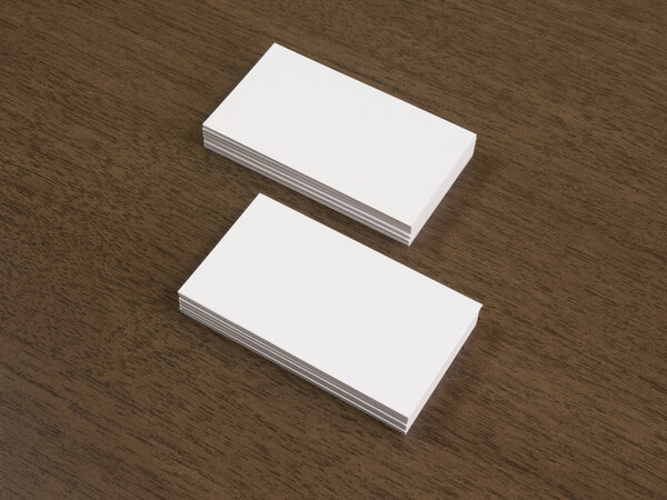 Empty business cards mockup on brown wooden table.