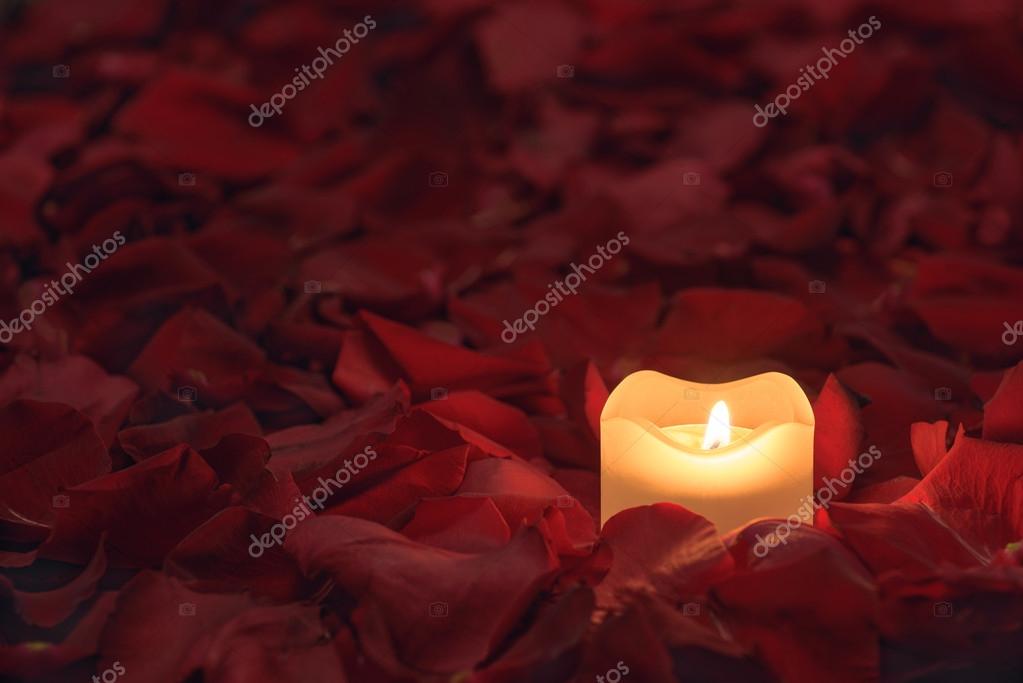 Candle on the rose petals background Stock Photo by ©aivo 62384609