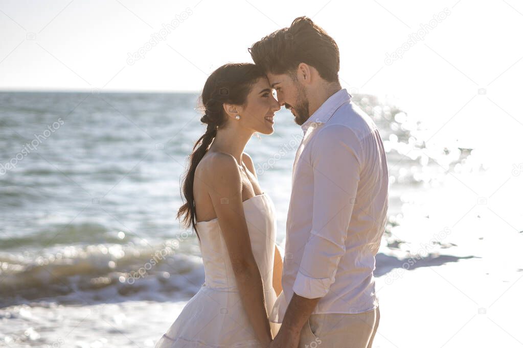 Wedding beach young couple sunset sand white happy sea waves