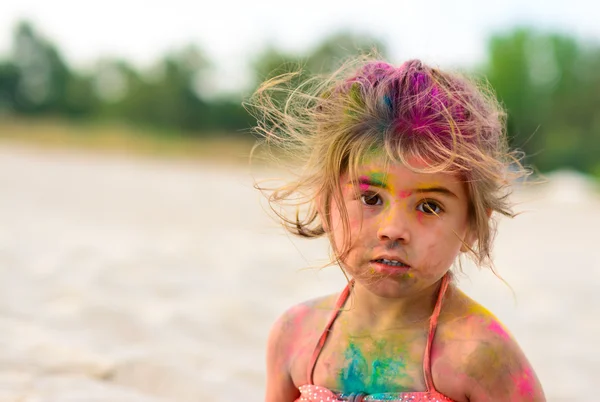 Cte young little girl with colored face, beach party — Stock Photo, Image