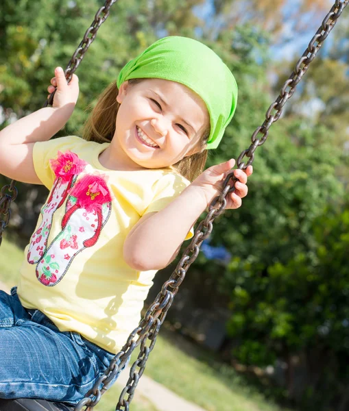 Pretty little girl on outdoor seesaw — Stock Photo, Image