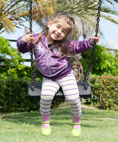 Pretty little girl on outdoor seesaw — Stock Photo, Image