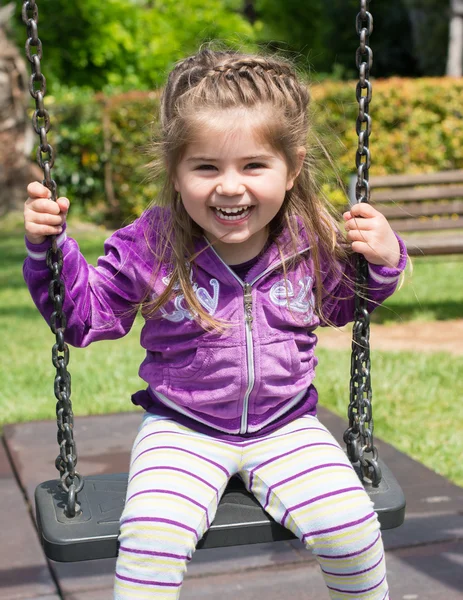 Pretty little girl on outdoor seesaw — Stock Photo, Image