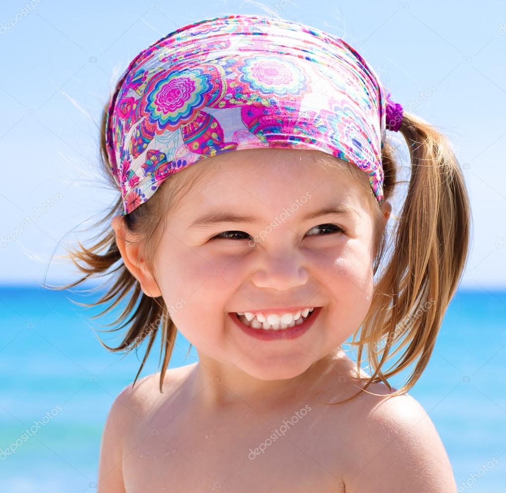 Happy smiling little girl on clear and tropical sea background Stock ...