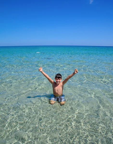 Kleine jongen in zeewater — Stockfoto