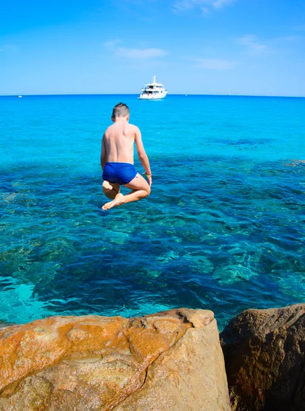 Boy jumping in sea — Stock Photo, Image