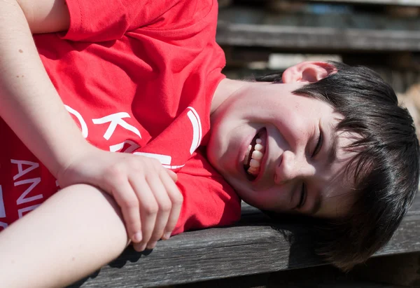 Junge liegt auf Bank — Stockfoto