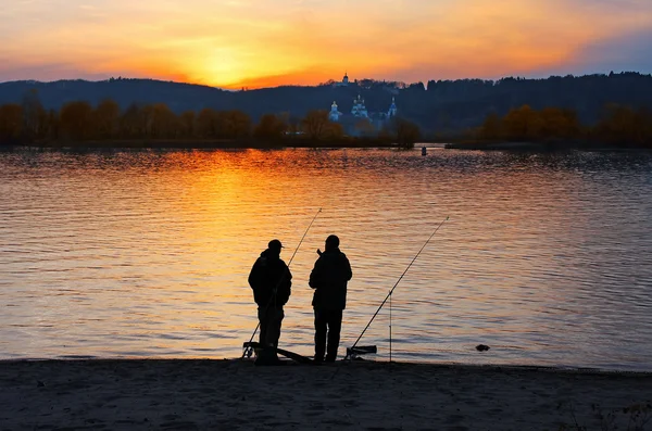 Two fishermans at sunset