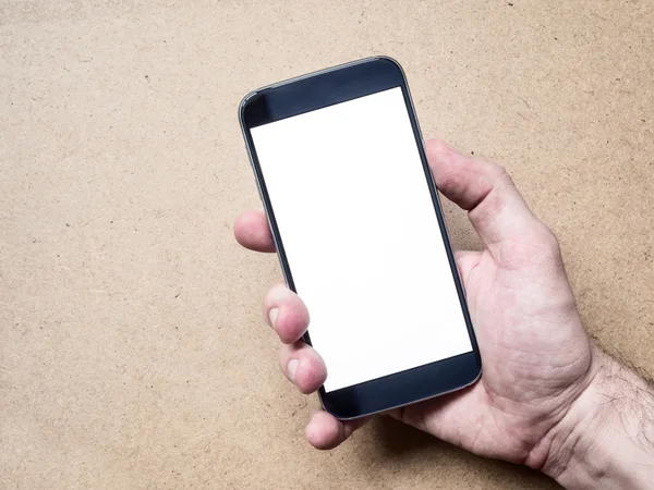 Mano celebración de teléfono inteligente móvil con pantalla blanca en blanco —  Fotos de Stock