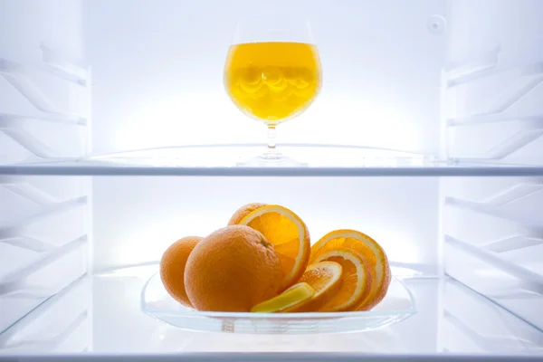 Refrigerator,  modern stylish design. Interior, inside  image, glass shelf, oranges, cocktail, jelly bean, clean, light, web banner — Stock Photo, Image