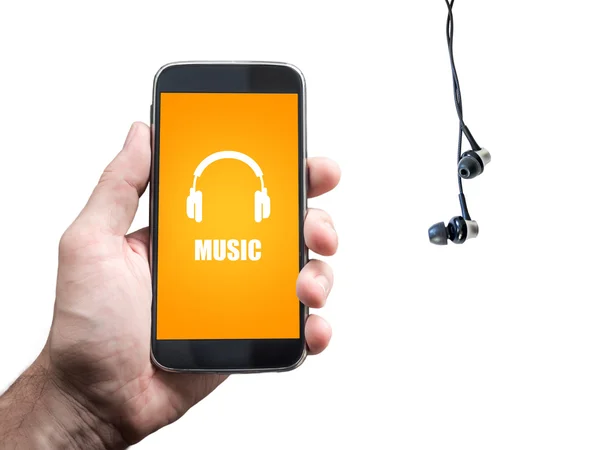 Ruka držící mobilní smartphone se sluchátky, izolovaných na bílém, hudební ikonu — Stock fotografie