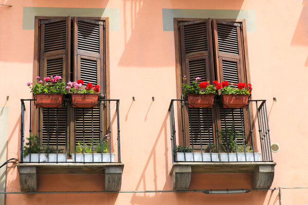 Pretty flower boxes stand on the balconies of Mediterranean houses