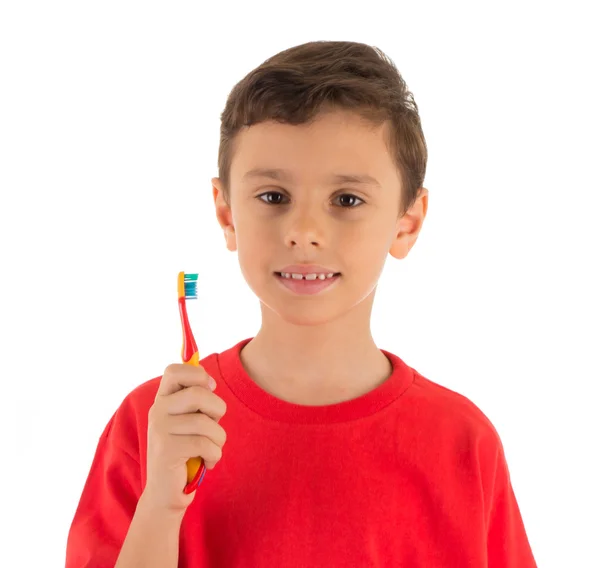 Boy smiling and holding a tooth brush ready to brush his teeth Stock Picture