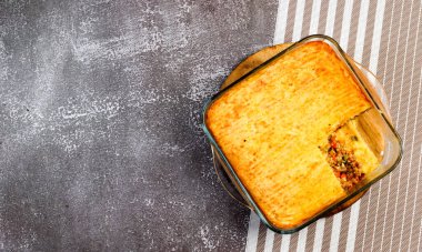 Çoban turtası - kıyma, patates püresi ve sebze güveci koyu bir arka planda. Üst manzara, düz uzanma