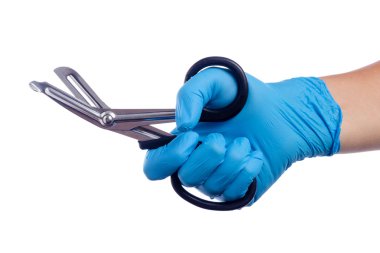 Hand with blue gloves holding trauma sheers