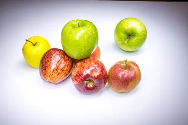 Fresh lucky seven multicolored apples painted in light — Stock Photo, Image