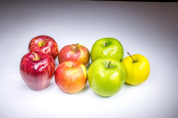 Fresh lucky seven multicolored apples painted in light