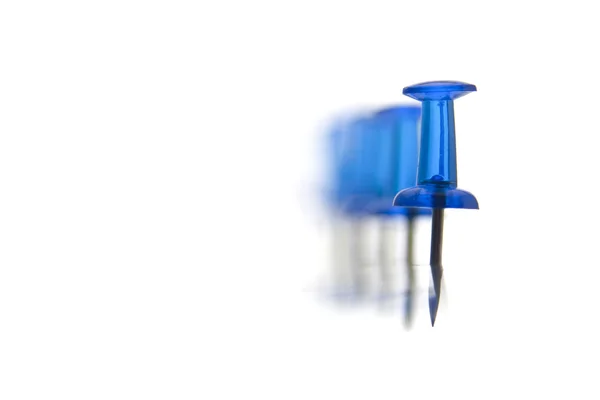 Blue pins in a row, defocused into the deep — Stok fotoğraf