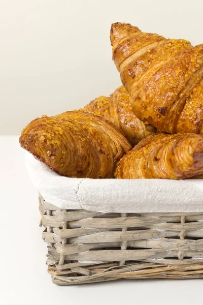 Tasty croissants in wicker basket on white background. French food. Close up — Foto de Stock