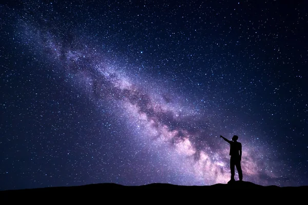 Gece manzarası ile Samanyolu ve bir adam silüeti