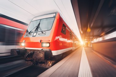 Modern high speed red passenger commuter train. Railway station