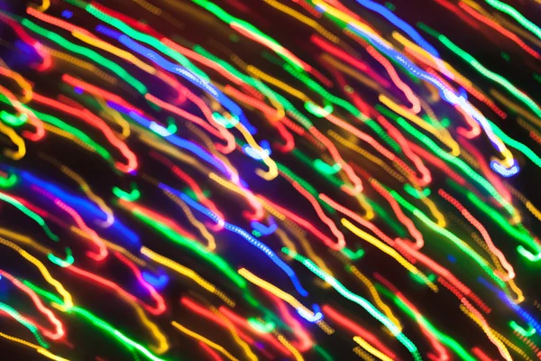 Defokussierte Weihnachtsbeleuchtung mit Bewegungsunschärfe. Neujahrsbokeh. abs — Stockfoto