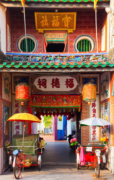 Rickshaw tricycles near the entrance to Hock Teik Cheng Sin Temple, Penang