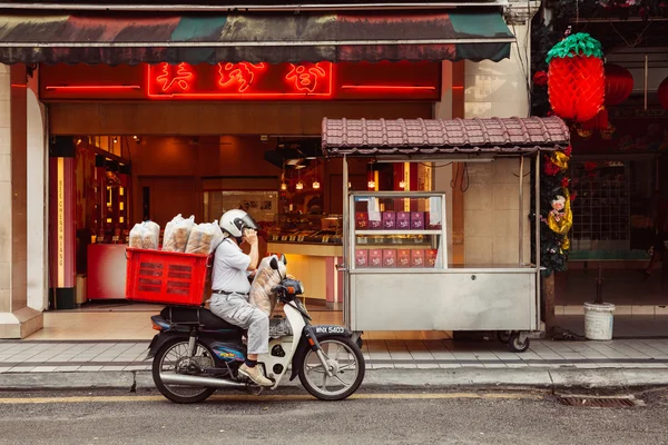 Delivering noodles to Chinese restaurant, Kuala Lumpur, Malaysia