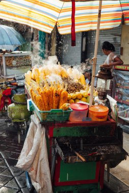 Street food stall with grilled corn, Bali clipart