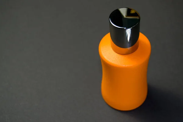 Frasco Perfume Naranja Con Una Tapa Brillante Sobre Fondo Negro —  Fotos de Stock