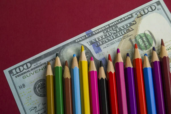 Multicolored Pencils Souvenir Dollar Bills Items Lie Red Background — Stock Photo, Image