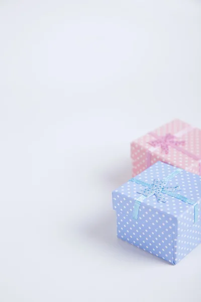 Blue and pink spotted squared gift boxes on light background — Stock Photo, Image