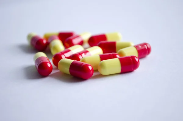 Red and yellow capsules on a light background — Stock Photo, Image