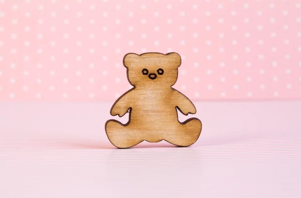 Wooden icon of Teddy bear on pink background — Stock Photo, Image