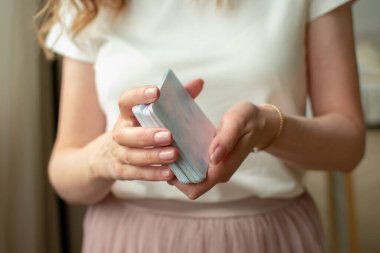 Kadın eli kartları tutuyordu. Seçici bir odak ile çekilmiş bir fotoğraf ve gürültü etkisi var. İyileştirici. Mecazi kartlar