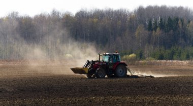 Traktör gündüz sahada çalışıyor.