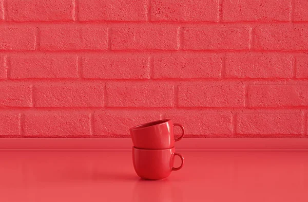 两个鲜红的咖啡杯叠置在平坦的单色红色厨房台面上 上面有砖墙 前视图和特写 — 图库照片