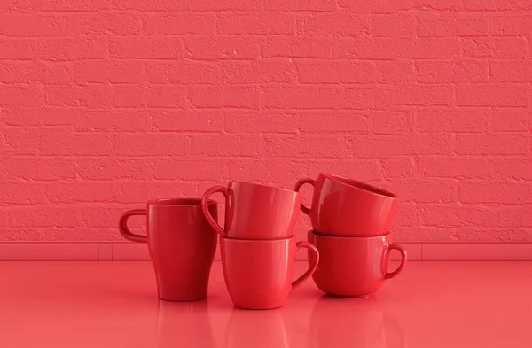 单色红色咖啡杯叠置在平坦的单色红色厨房台面上 配有砖墙 前视图和特写 — 图库照片