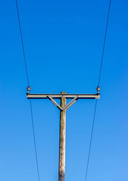 Two Power Lines Insulators Wooden Telegraph Pole Blue Background — Stock Photo, Image