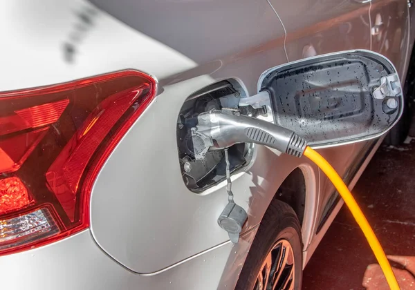 A charging cable plugged in to an electric car.