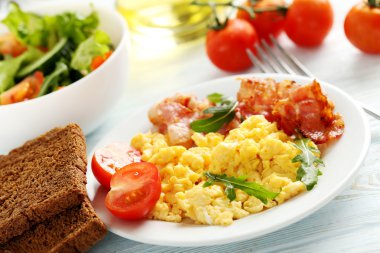 Scrambled eggs with bacon and vegetables clipart