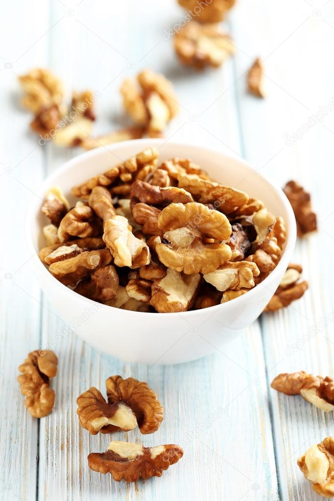 Walnuts in bowl on white