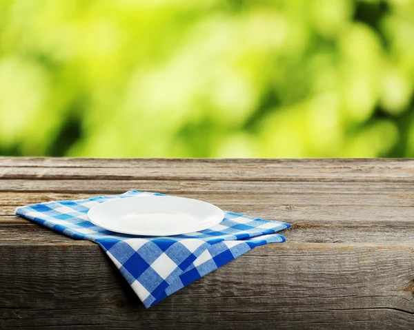 Table with white plate — Stock Photo, Image