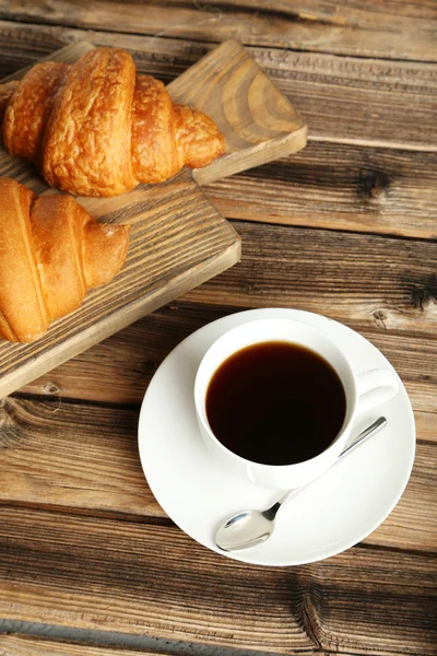 Tasty croissants with cup of coffee — Stock Photo, Image