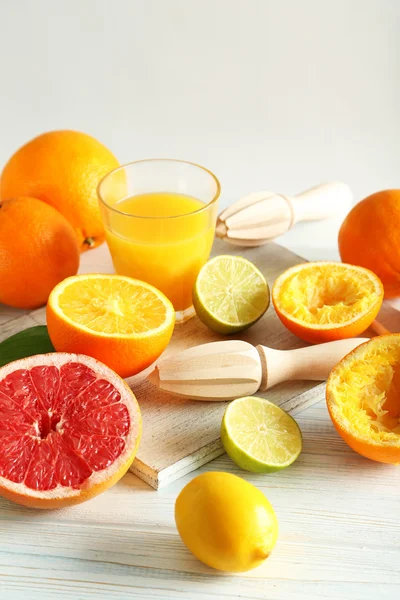 Citrus fruits with juicer — Stock Photo, Image